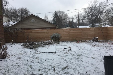 Wood fence snowy yard